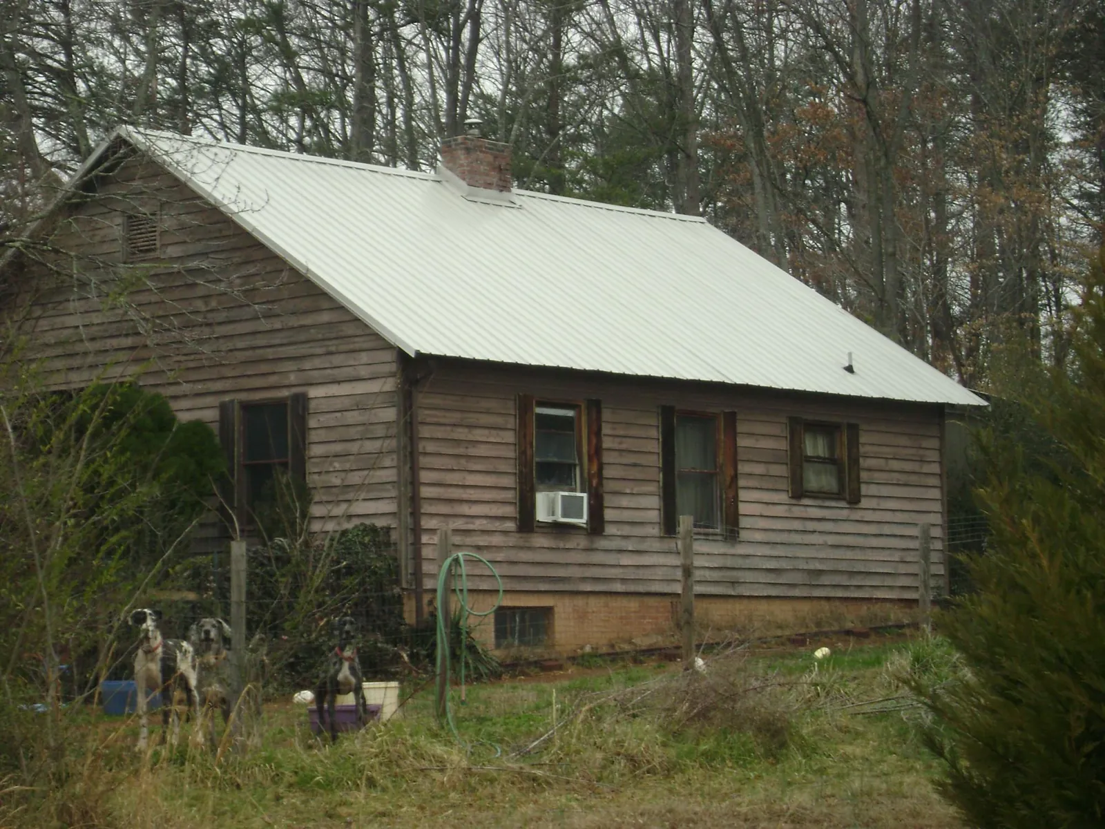White metal roof on an old wood sided farmhouse, from a Metal Roof Installation job in Saint George